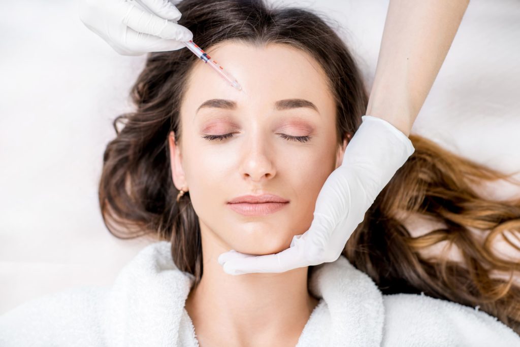 Closed Eyes Lying Woman Receiving Wrinkle relaxer Injection | Noble Clinic in Draper, UT