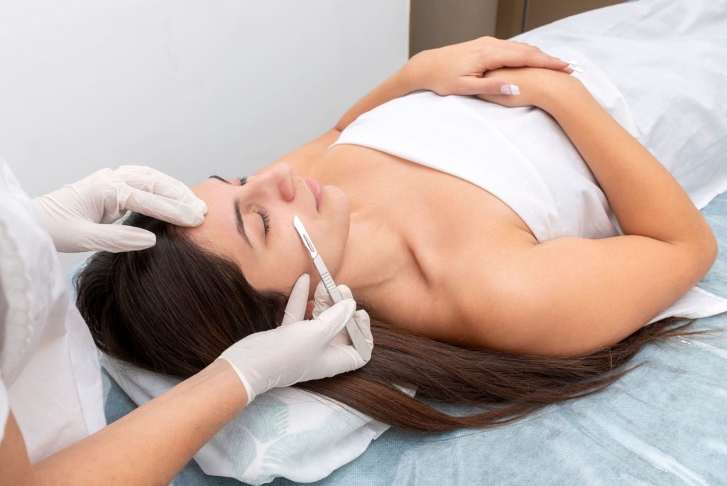 Closed Eyes Lying Woman Getting Dermaplanning Treatment | Noble Clinic in Draper, UT