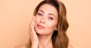 Woman touching her smooth face after non-surgical skin tightening with THERMAGE® FLX in Draper, UT.